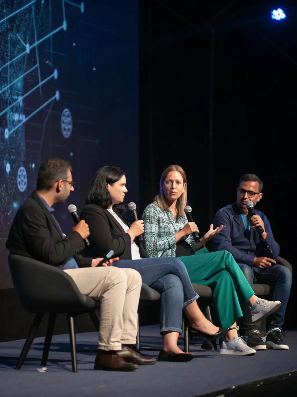 A close-up shot of a panel discussion featuring three experts in AI ethics, highlighting their diverse backgrounds and thoughtful expressions.